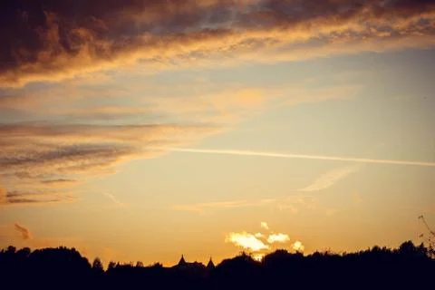 Evening sunset with clouds on the background of the shadows of buildings 스톡 사진