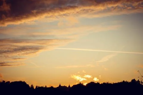 Evening sunset with clouds on the background of the shadows of buildings 스톡 사진