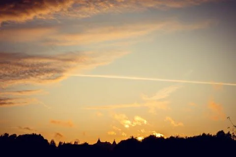 Evening sunset with clouds on the background of the shadows of buildings Фото