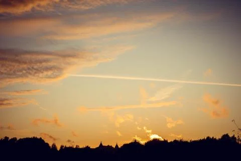 Evening sunset with clouds on the background of the shadows of buildings 스톡 사진