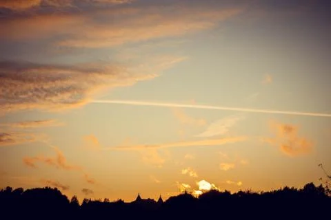 Evening sunset with clouds on the background of the shadows of buildings Фото