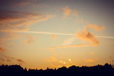 Evening sunset with clouds on the background of the shadows of buildings Фото