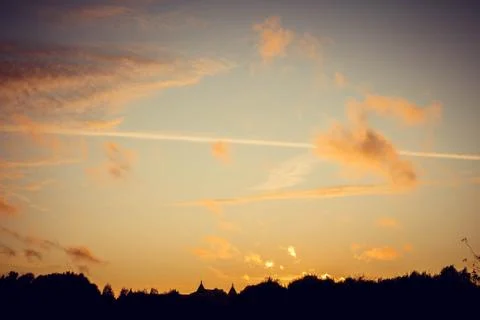 Evening sunset with clouds on the background of the shadows of buildings 스톡 사진
