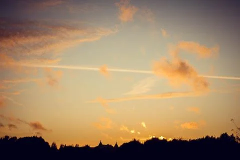Evening sunset with clouds on the background of the shadows of buildings Stock Photos