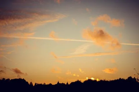 Evening sunset with clouds on the background of the shadows of buildings Fotos Stock