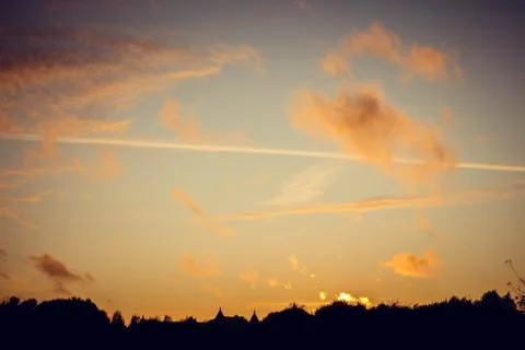 Evening sunset with clouds on the background of the shadows of buildings Фото