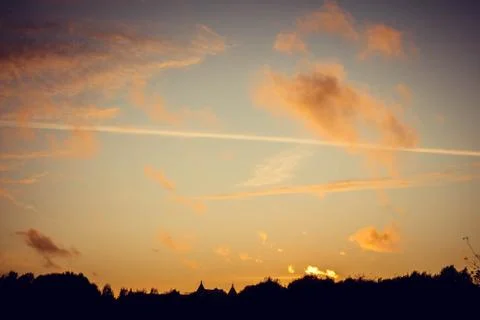 Evening sunset with clouds on the background of the shadows of buildings 스톡 사진