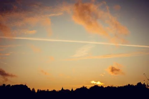 Evening sunset with clouds on the background of the shadows of buildings 스톡 사진