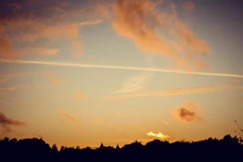 Evening sunset with clouds on the background of the shadows of buildings Фото