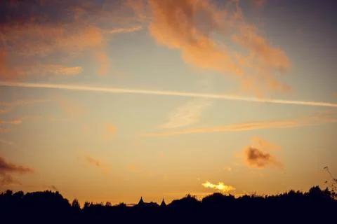 Evening sunset with clouds on the background of the shadows of buildings Фото