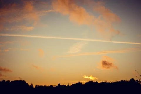 Evening sunset with clouds on the background of the shadows of buildings 스톡 사진