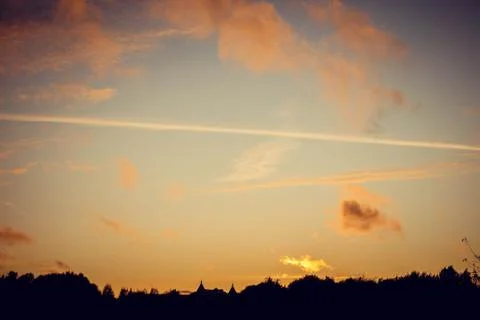 Evening sunset with clouds on the background of the shadows of buildings Фото
