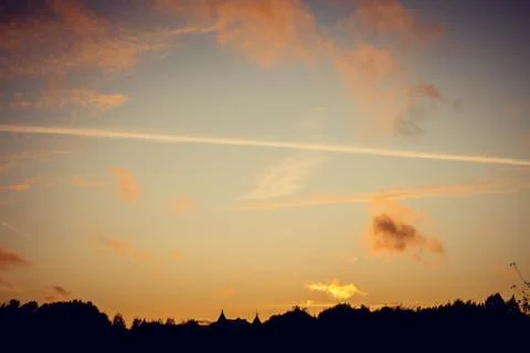 Evening sunset with clouds on the background of the shadows of buildings 스톡 사진