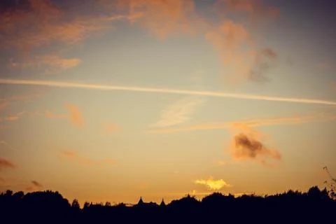 Evening sunset with clouds on the background of the shadows of buildings 스톡 사진