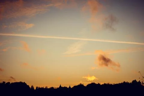 Evening sunset with clouds on the background of the shadows of buildings 스톡 사진