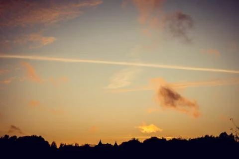 Evening sunset with clouds on the background of the shadows of buildings Фото