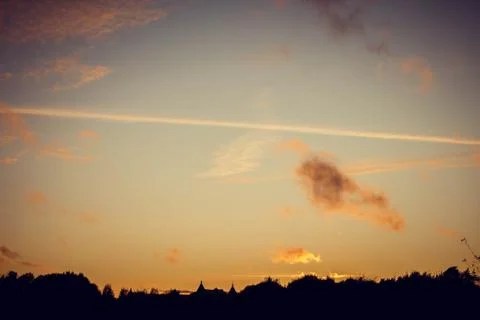 Evening sunset with clouds on the background of the shadows of buildings Stockfoto's