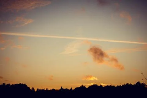 Evening sunset with clouds on the background of the shadows of buildings Stock Photos