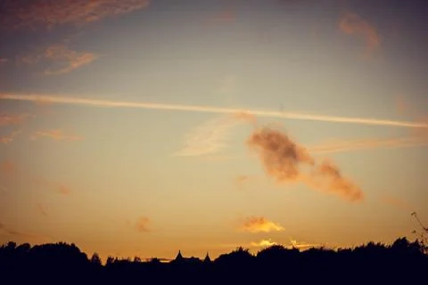 Evening sunset with clouds on the background of the shadows of buildings 스톡 사진