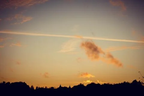 Evening sunset with clouds on the background of the shadows of buildings 스톡 사진