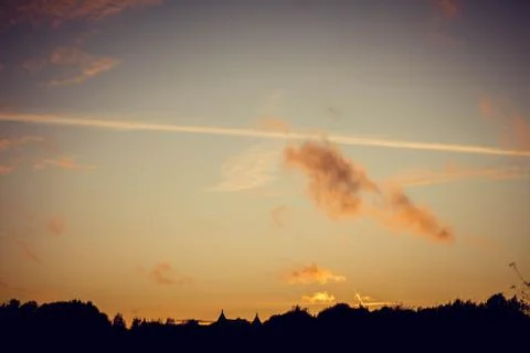 Evening sunset with clouds on the background of the shadows of buildings Stockfoto's