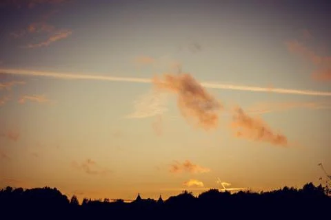 Evening sunset with clouds on the background of the shadows of buildings Stockfoto's