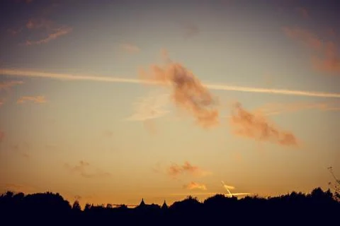 Evening sunset with clouds on the background of the shadows of buildings 스톡 사진