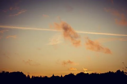 Evening sunset with clouds on the background of the shadows of buildings 스톡 사진