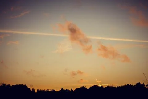 Evening sunset with clouds on the background of the shadows of buildings Фото