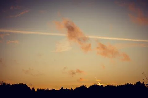 Evening sunset with clouds on the background of the shadows of buildings Stockfoto's