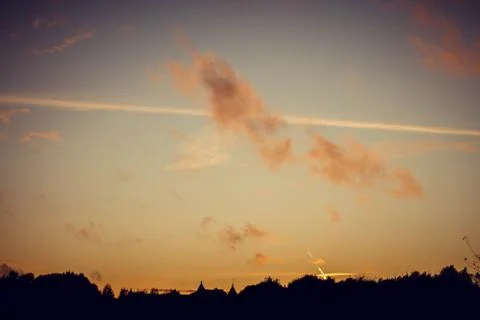Evening sunset with clouds on the background of the shadows of buildings Фото