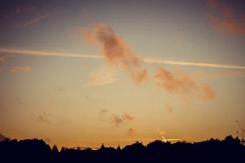 Evening sunset with clouds on the background of the shadows of buildings Фото