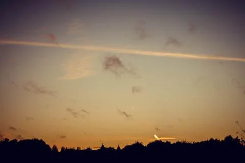 Evening sunset with clouds on the background of the shadows of buildings Фото