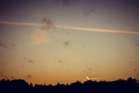 Evening sunset with clouds on the background of the shadows of buildings 库存照片