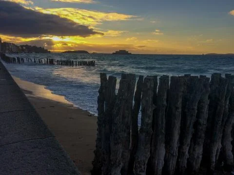 Evening sunset with clouds on ocean beach Stock Photos
