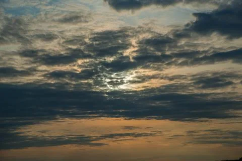 Evening sunset in dark clouds Stock Photos