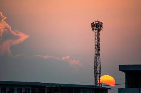 Evening sunset light is orange after the telephone receiver antenna. Stock Photos