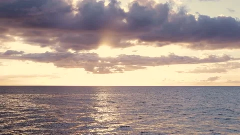Evening sunset, morning sunrise ocean view with clouds, calm ripple waves loop Stock Footage