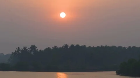 Evening sunset over island with trees near river- Kerala, India 動画素材 113046442