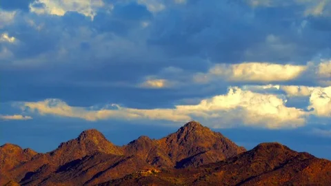 Evening sunset over jagged mountain range with stormy clouds in Arizona Stock Footage 75479501