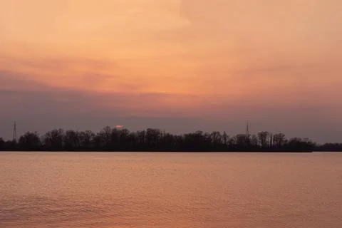 Evening sunset on a river. Early spring landscape. Stock Photos
