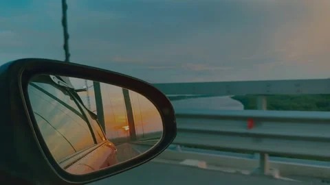 The evening sunset is seen in the reflection in the car mirror. Twilight. Stock Footage 287109831