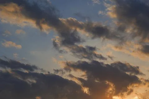 Evening sunset, sky above the clouds with dramatic yellow light. 库存照片