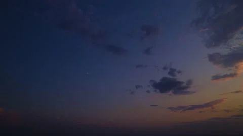 An evening sunset sky that is colored with a blue and golden gradient. The Stock Footage 231897882