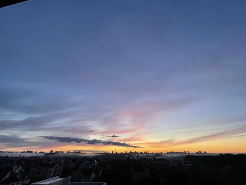 Evening sunset, the sun is setting on the horizon clouds and sky Stock Photos