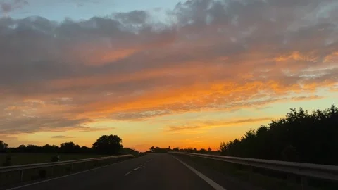 Evening sunset view from a driving car on the road Video stock 310856891