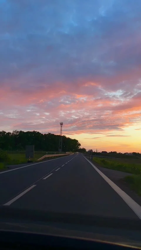 Evening sunset view from a driving car on the road Stock Footage 310856892