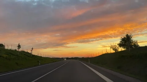 Evening sunset view from a driving car on the road Video stock 310856900