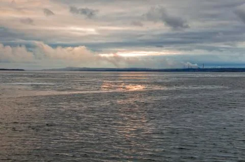 Evening, the sunset visible through strong clouds over the Volga River Stock Photos