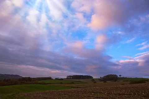 Evening sunshine background with clouds dramatic sky. Stock Photos